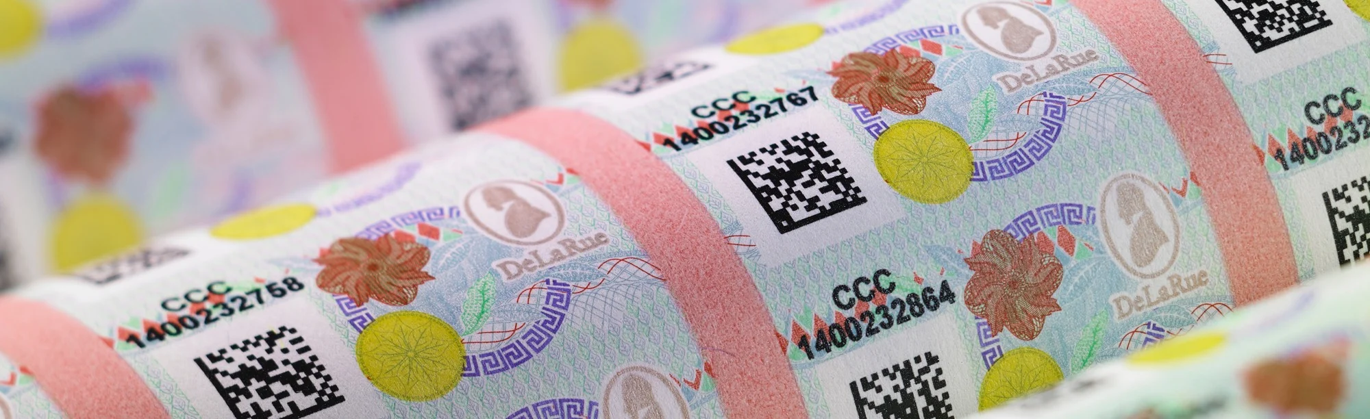 Close-up of alcohol production line worker applying secure GRS Authentication labels