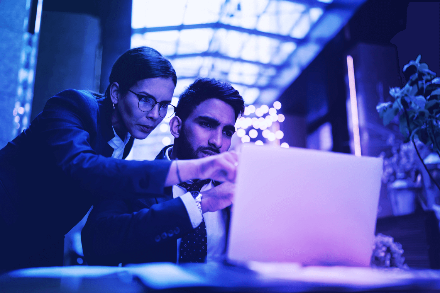 Two people viewing the Crane Authentication website on a computer to explore online brand protection and security services