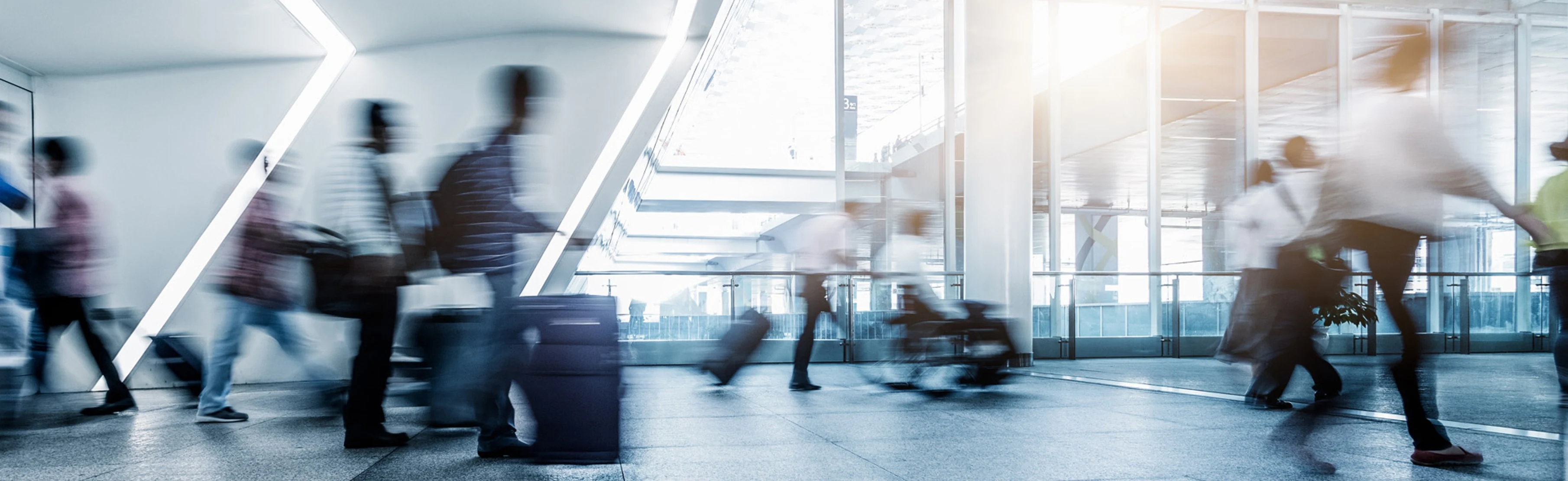 Fast-moving airport scene with people blurred in slow motion as they go about their day