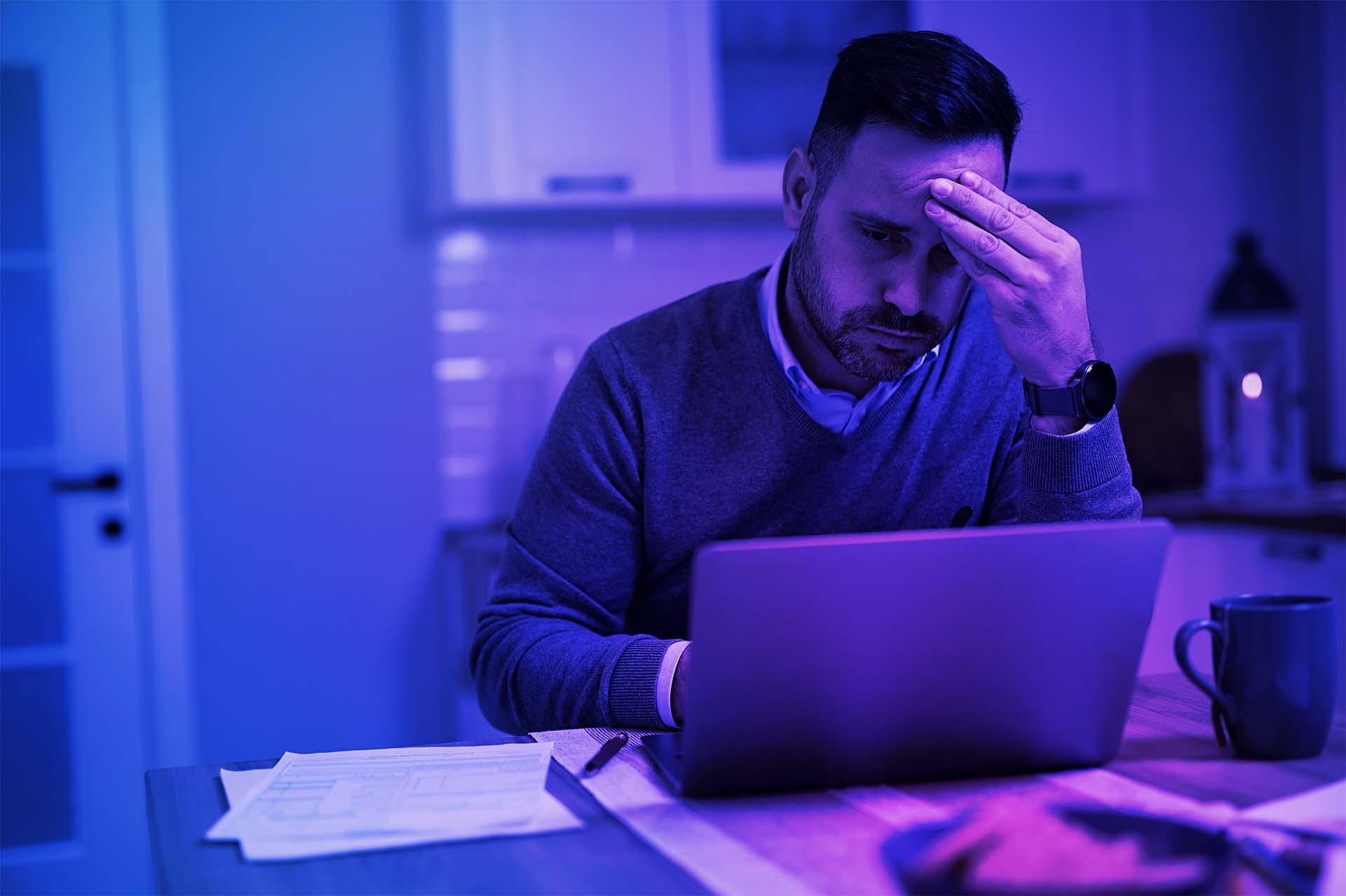 Online Fraud Protection-Distraught businessman looking at laptop