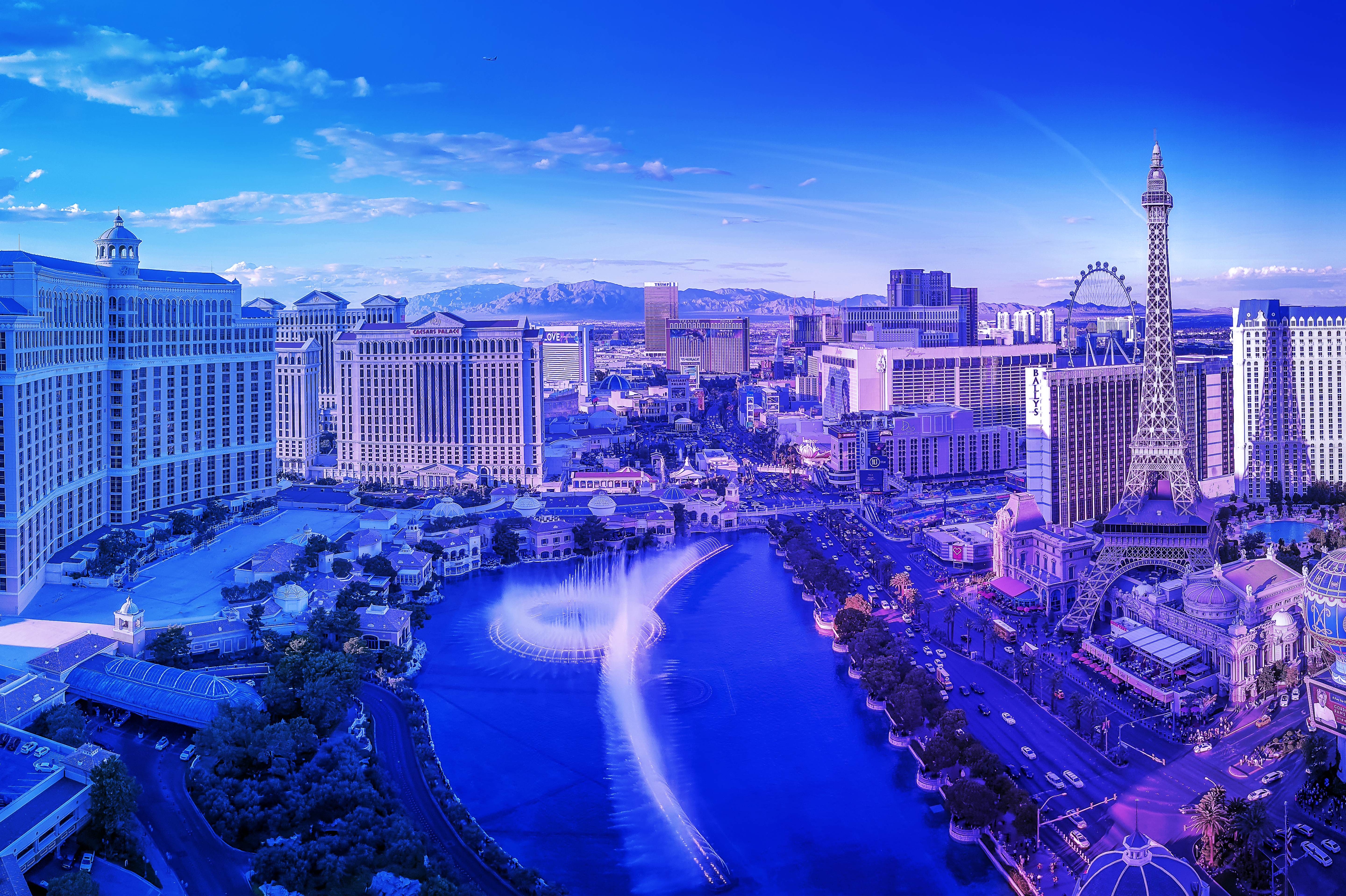 Wide view of the Las Vegas Strip with the Bellagio fountain lake in the foreground