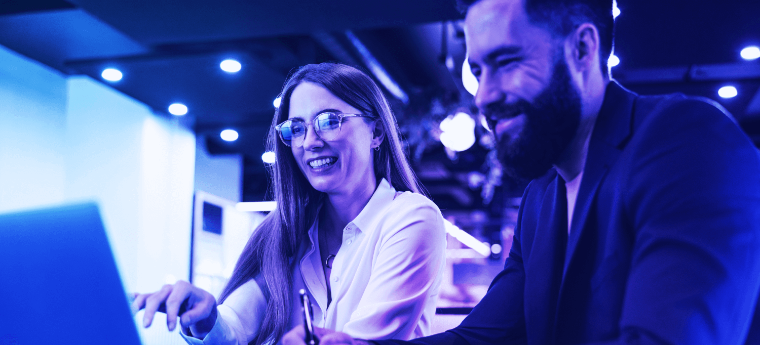 Two people looking at computer screen